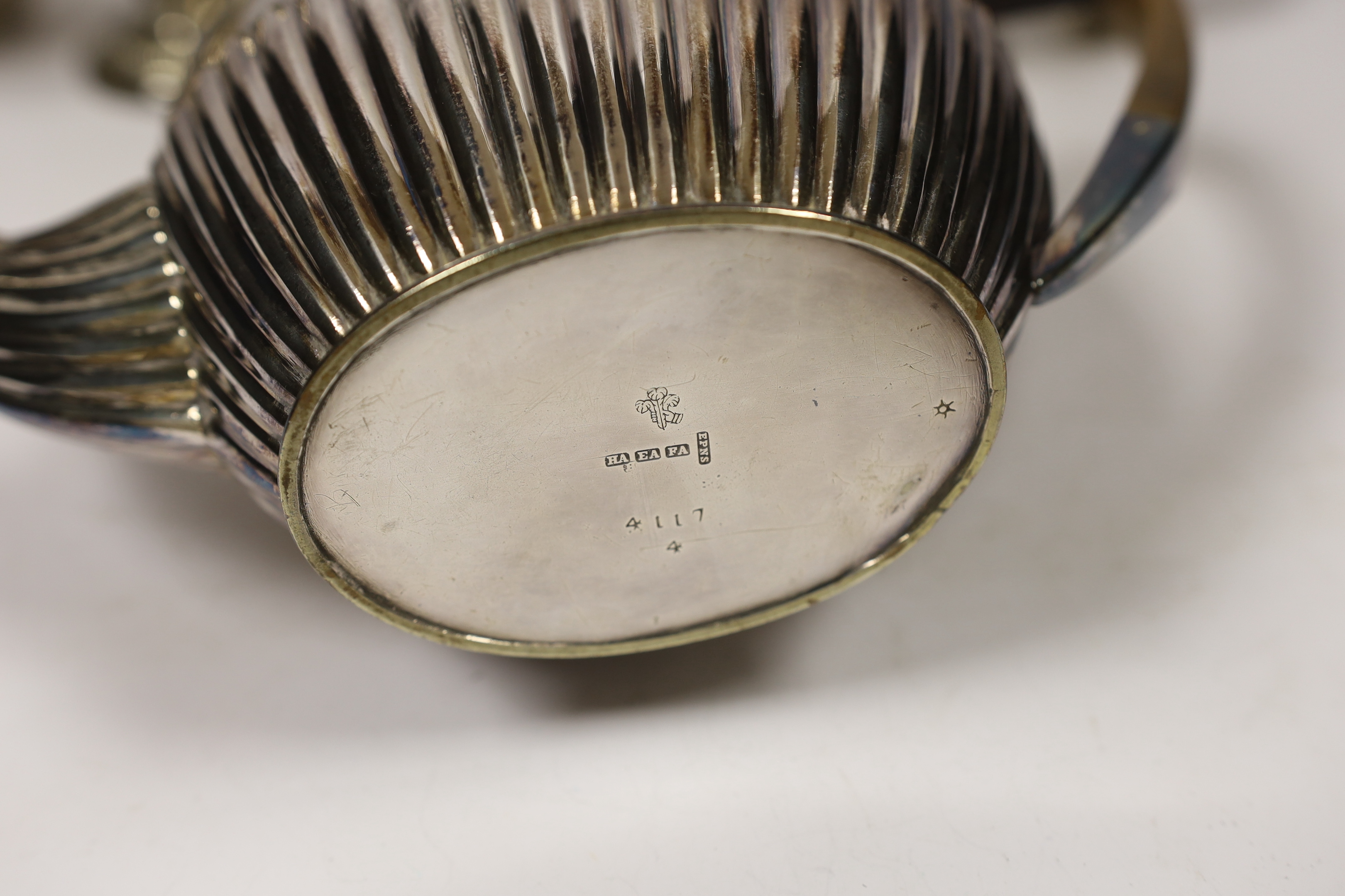 A late Victorian silver bachelor's oval teapot, Florence Warden, Chester, 1897, together with a small Edwardian silver sauceboat and four items of plated ware including a sugar caster and teapot